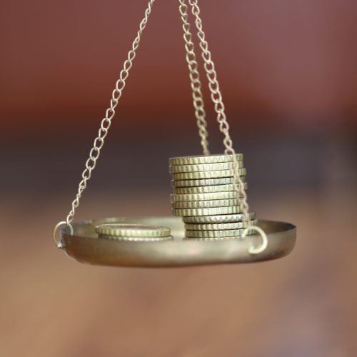 Coins stack with balance scale. Money management, financial plan, time value of money, business idea and Creative ideas for saving money concept.