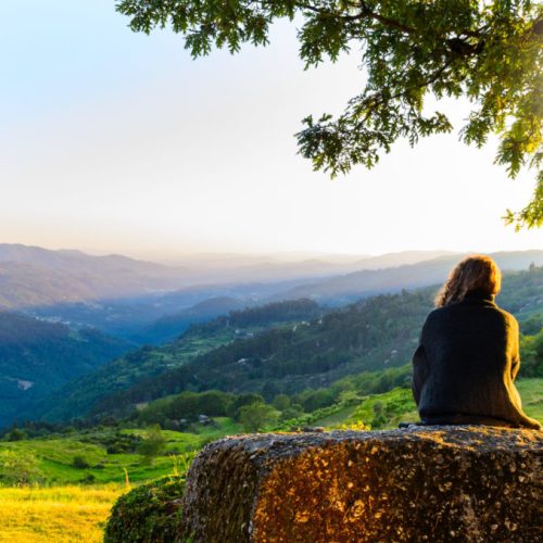 scenic view of woman watching at sunset mountains, Peneda-Geres National Park, northern Portugal.